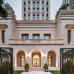 Elegant exterior view of a luxury building with sophisticated architectural details and lush greenery