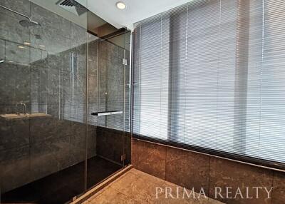 Modern bathroom with glass shower and elegant tiling