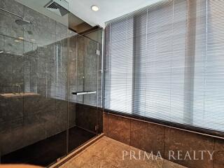 Modern bathroom with glass shower and elegant tiling