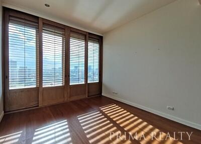 Spacious bedroom with large windows and natural light