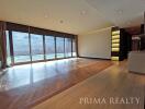 Spacious living room with large windows and city view