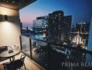 City view from high-rise apartment balcony at dusk with outdoor seating