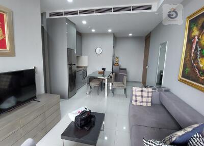 Modern furnished living room with kitchen and dining area