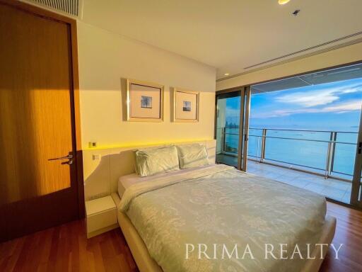 Modern bedroom with ocean view and balcony access