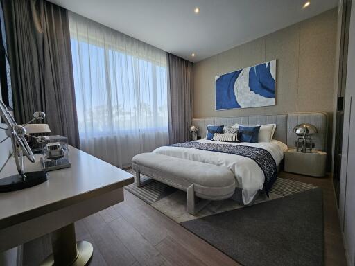 Modern bedroom with elegant design and ocean-themed artwork