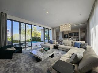 Spacious modern living room with large windows and luxurious decor
