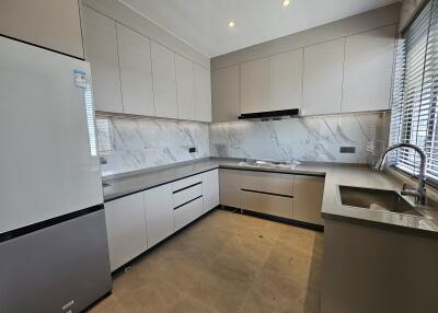 Modern kitchen with marble countertops and stainless steel appliances