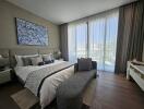 Spacious modern bedroom with large bed and artistic wall painting