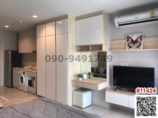 Modern bedroom with integrated kitchen appliances and entertainment unit