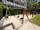 Children's playground with sandpit and swings in outdoor residential area
