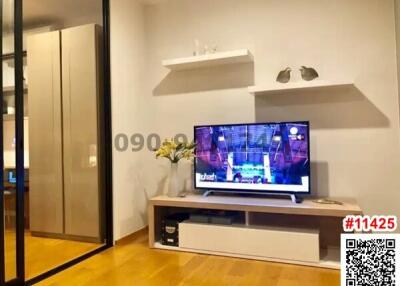 Modern living room with large TV and sleek furniture design