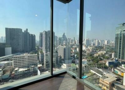 High-rise city view from a large glass window