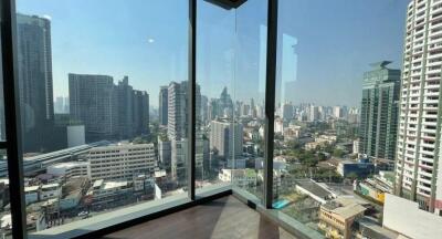 High-rise city view from a large glass window