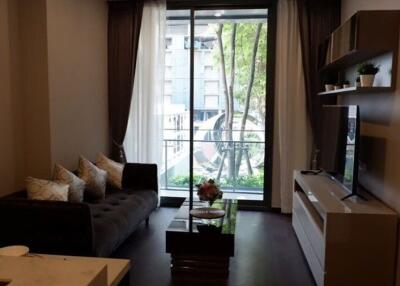 Modern living room with balcony access and ample natural light