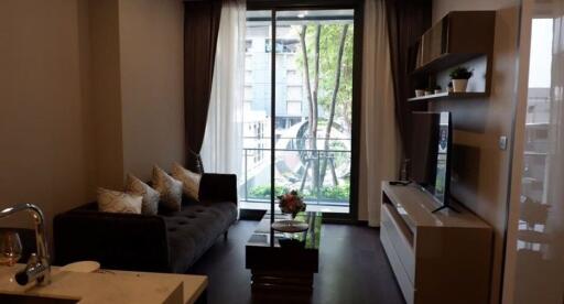 Modern living room with balcony access and ample natural light