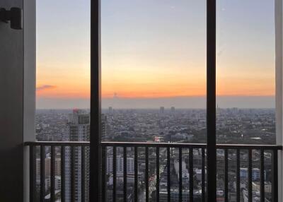 Stunning city view from high-rise balcony at sunset