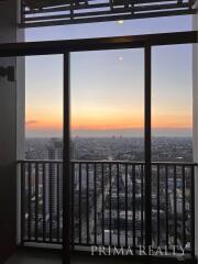 Stunning city view from high-rise balcony at sunset