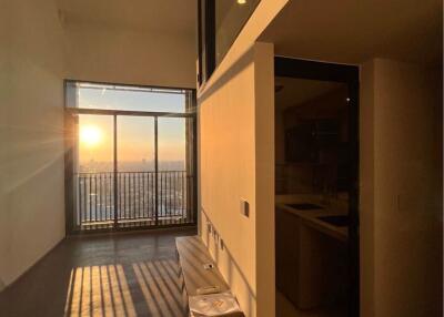 Sunset view from modern living room with balcony access