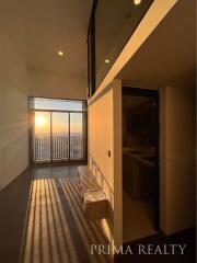 Sunset view from modern living room with balcony access