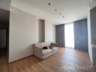 Spacious living room with natural light and hardwood floors