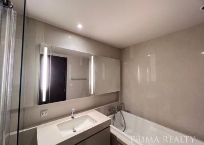 Modern bathroom with large mirror and well-lit vanity