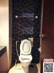 Compact modern bathroom with dark tiles