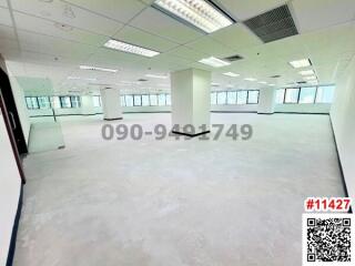 Spacious and bright empty office space with large windows