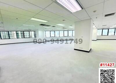 Spacious unfurnished office space with large windows and ample natural light