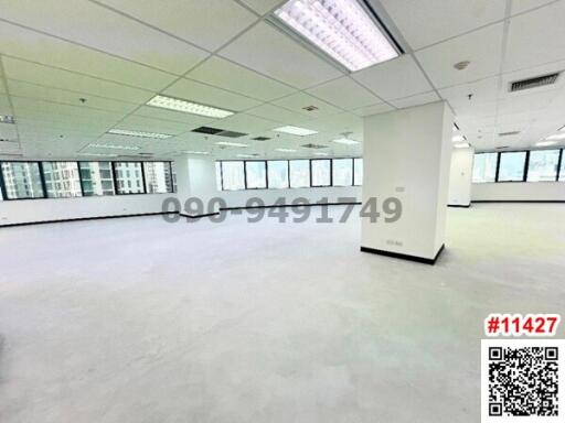 Spacious unfurnished office space with large windows and ample natural light