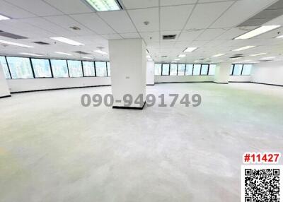 Spacious empty commercial office space with large windows