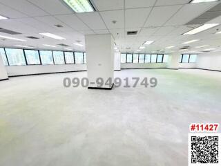 Spacious empty commercial office space with large windows