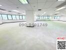 Spacious empty commercial office space with large windows