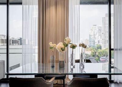 Elegant living room with a view of the city skyline through large glass windows