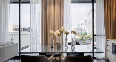 Elegant living room with a view of the city skyline through large glass windows