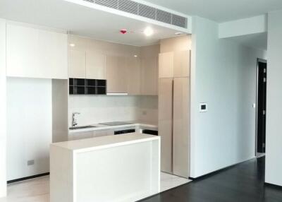 Modern kitchen with white cabinetry and black countertops in a new apartment