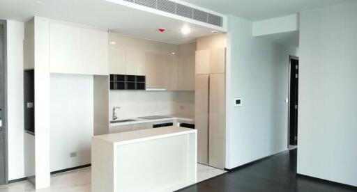 Modern kitchen with white cabinetry and black countertops in a new apartment