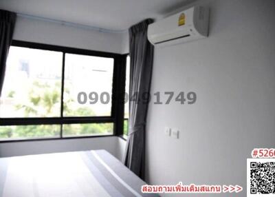 Bright and modern bedroom with large window and air conditioning unit
