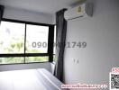 Bright and modern bedroom with large window and air conditioning unit