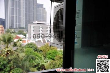 View from balcony with air conditioning unit overlooking urban landscape