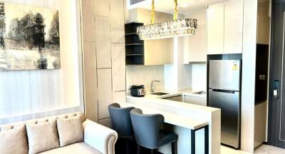 Modern kitchen with integrated living space featuring elegant furnishings and bright decor