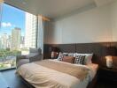 Modern bedroom with city view through large window