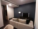 Modern living room interior with a comfortable beige sofa and chic dark blue wall