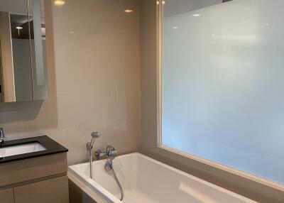 Modern bathroom with sleek tub and ambient lighting