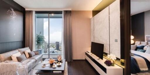 Modern apartment living area with an open view to the bedroom, featuring elegant decor and ample natural light