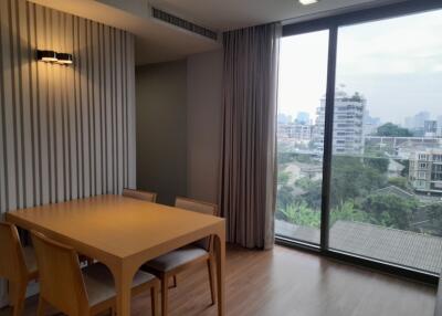 Spacious living room with large window and dining area