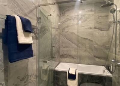 Modern Bathroom with Glass Shower Enclosure and Marble Walls