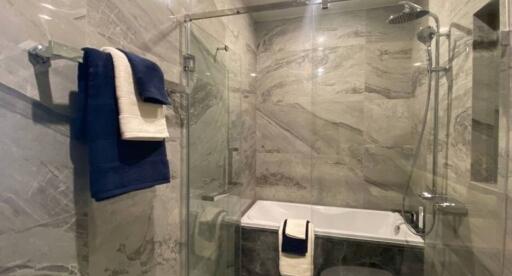 Modern Bathroom with Glass Shower Enclosure and Marble Walls