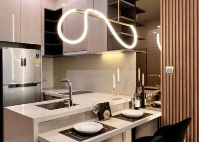 Modern kitchen with integrated appliances and stylish lighting fixtures