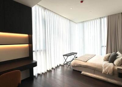 Modern bedroom with ample natural light and chic furnishings