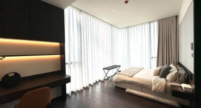 Modern bedroom with ample natural light and chic furnishings